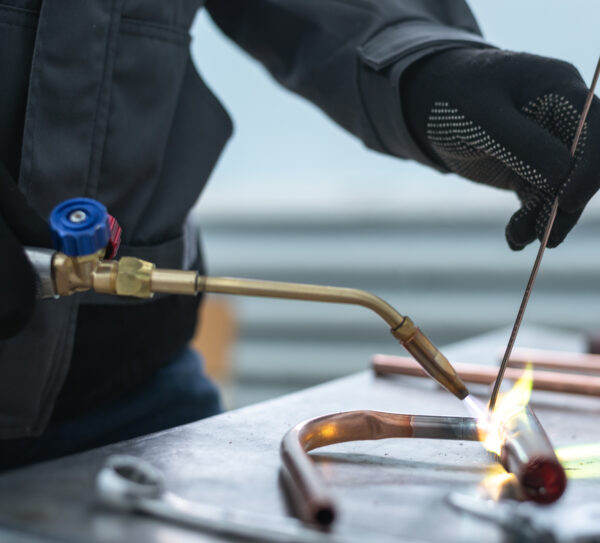 Worker,Is,Soldering,A,Pipe,By,A,Blow,Lamp,On